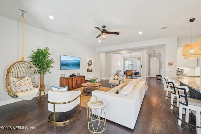 living room with dark hardwood / wood-style floors and ceiling fan