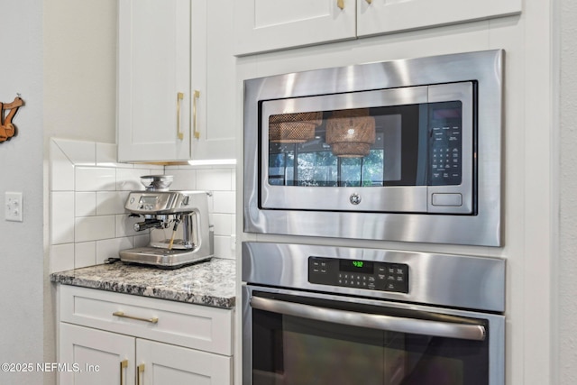 kitchen featuring light stone counters, tasteful backsplash, white cabinets, and appliances with stainless steel finishes