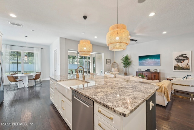 kitchen featuring white cabinetry, sink, decorative light fixtures, and dishwasher