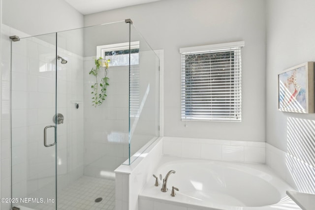 bathroom featuring independent shower and bath