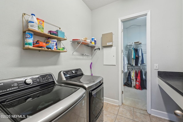 laundry area featuring separate washer and dryer and light tile patterned floors