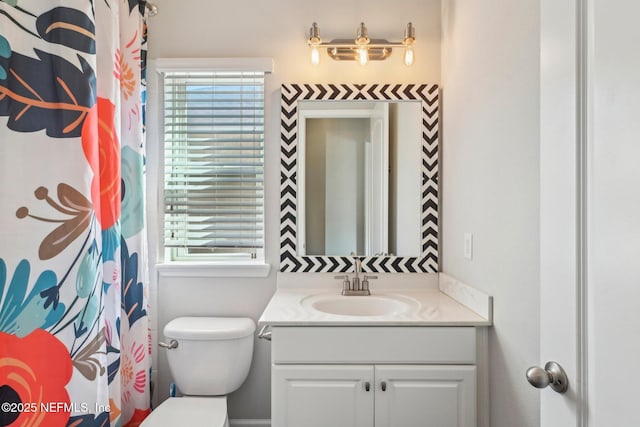 bathroom featuring vanity and toilet