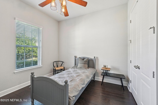 bedroom with dark hardwood / wood-style floors and ceiling fan