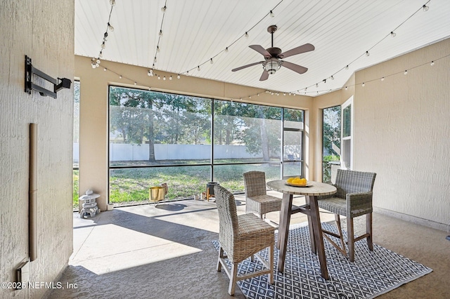 sunroom / solarium with track lighting and ceiling fan