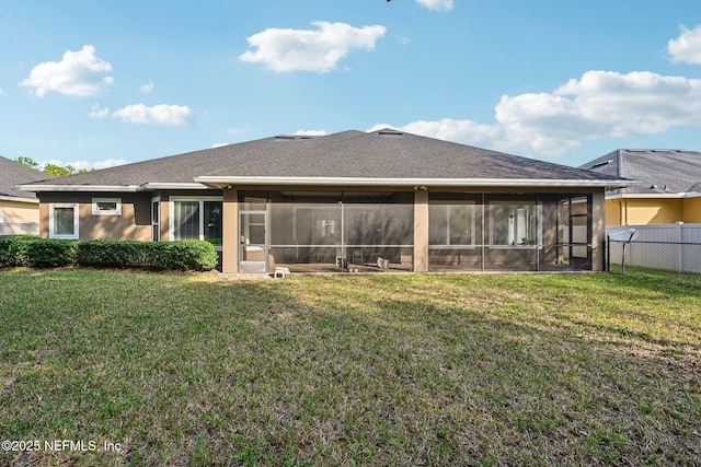 back of house featuring a sunroom and a yard