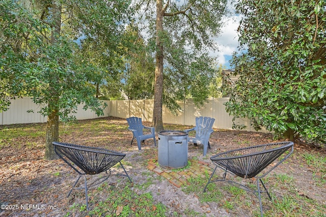 view of yard with a fire pit