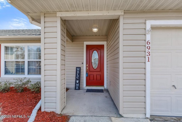 doorway to property featuring a garage