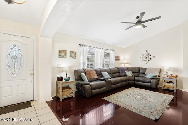 living room featuring hardwood / wood-style flooring, vaulted ceiling, and ceiling fan