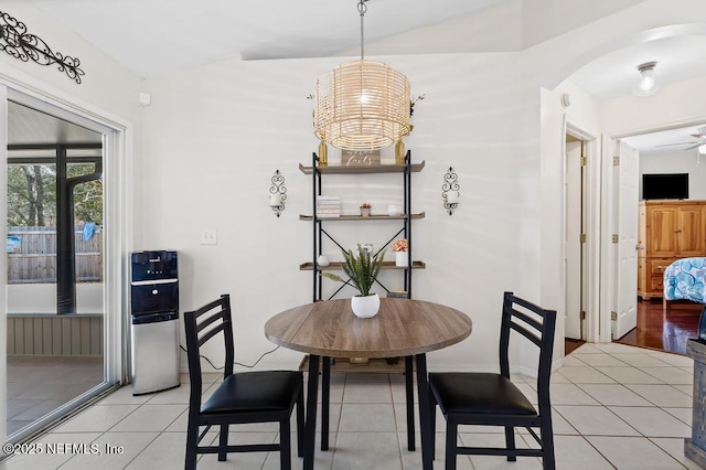 tiled dining space with lofted ceiling and ceiling fan