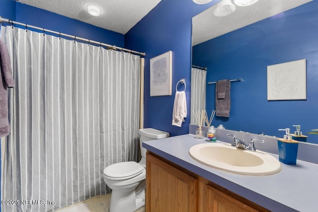 bathroom featuring vanity, a shower with curtain, toilet, and a textured ceiling