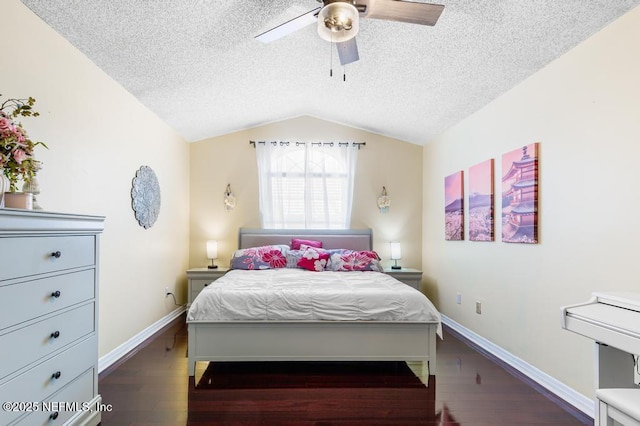 bedroom with vaulted ceiling, dark wood-type flooring, ceiling fan, and a textured ceiling