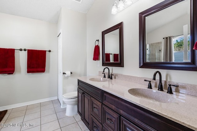 bathroom featuring tile patterned floors, toilet, and vanity