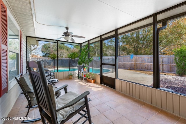 sunroom featuring ceiling fan