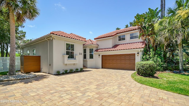 mediterranean / spanish home featuring a garage