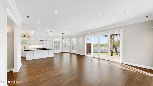 unfurnished living room with dark wood-type flooring and ornamental molding