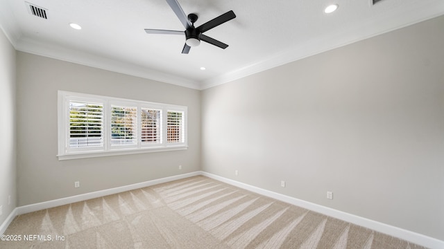 carpeted spare room featuring ornamental molding and ceiling fan