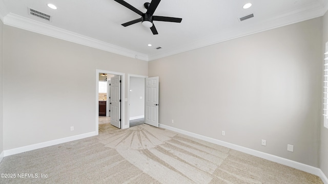 carpeted spare room featuring ornamental molding and ceiling fan