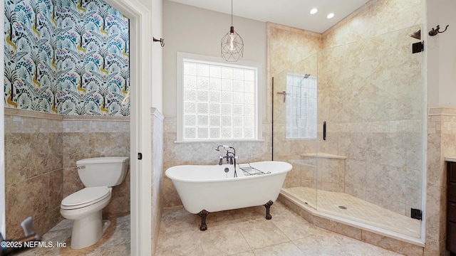 bathroom with plus walk in shower, tile walls, tile patterned floors, and toilet