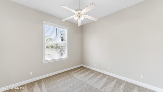 carpeted empty room with ceiling fan