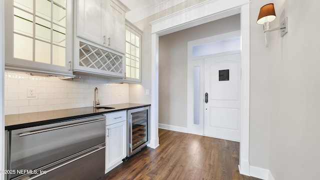 kitchen with wine cooler, decorative backsplash, dishwasher, and white cabinets