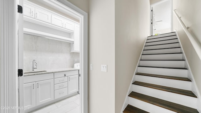 staircase with sink and tile patterned floors