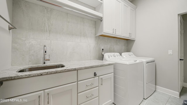 laundry area with cabinets, sink, and washing machine and clothes dryer