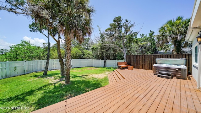 wooden deck featuring a yard and a hot tub