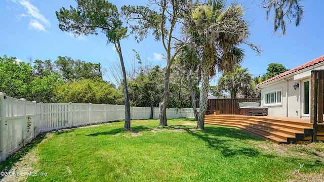 view of yard with a jacuzzi and a deck