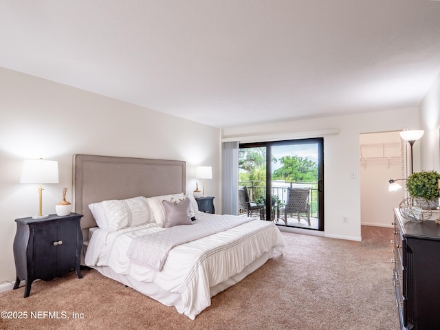 bedroom with a walk in closet, access to outside, and light colored carpet