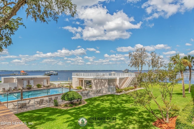 view of pool featuring a water view and a yard