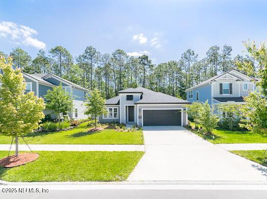 view of front of house featuring a garage and a front yard