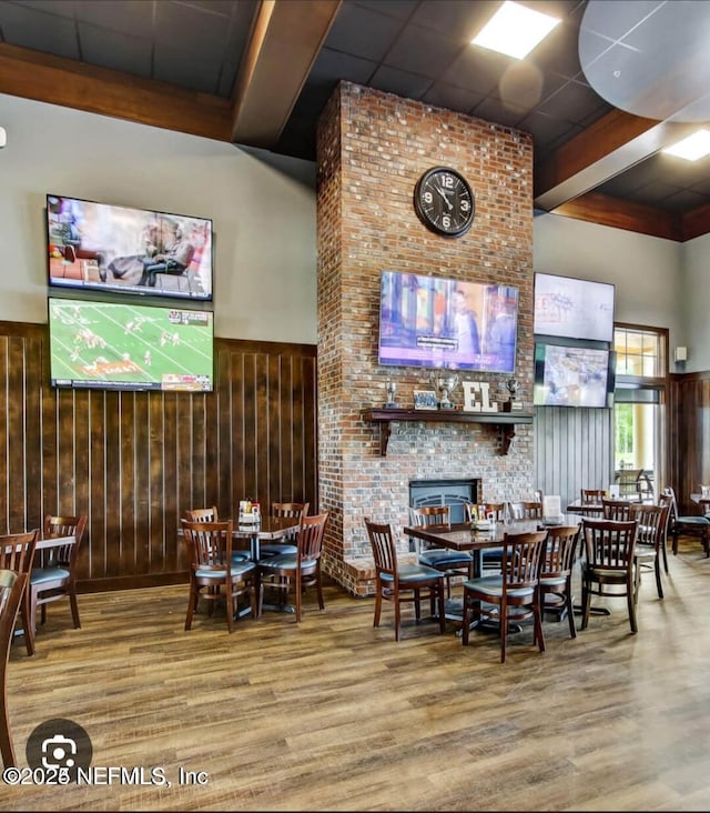 dining area with beamed ceiling and hardwood / wood-style floors