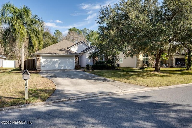 view of front of house featuring a garage and a front lawn