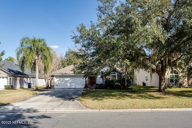 view of property hidden behind natural elements with a garage and a front lawn