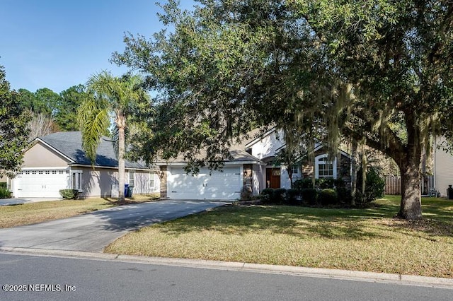 obstructed view of property with a garage and a front yard