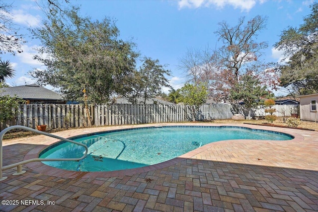 view of swimming pool with a patio area, a fenced backyard, and a fenced in pool