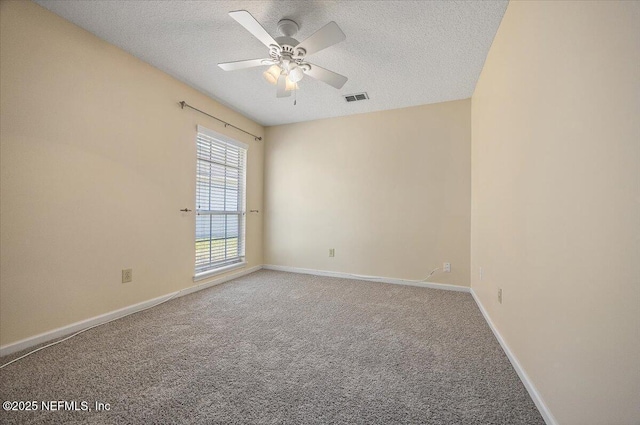 carpeted empty room with ceiling fan and a textured ceiling