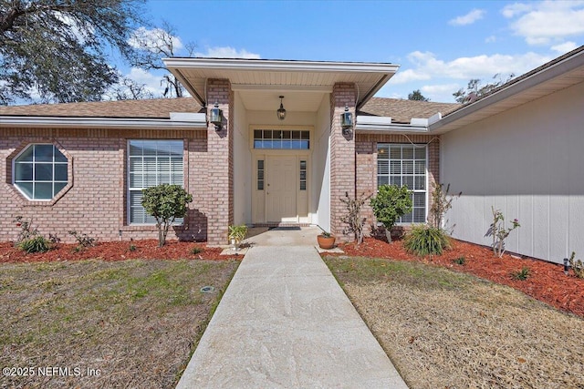 doorway to property with a lawn