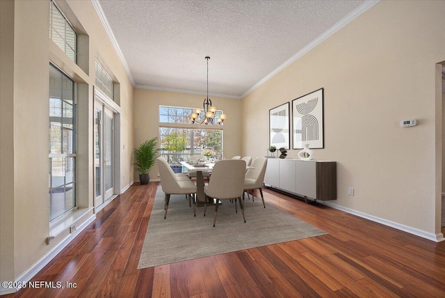 dining space with an inviting chandelier, dark wood-type flooring, ornamental molding, and a textured ceiling