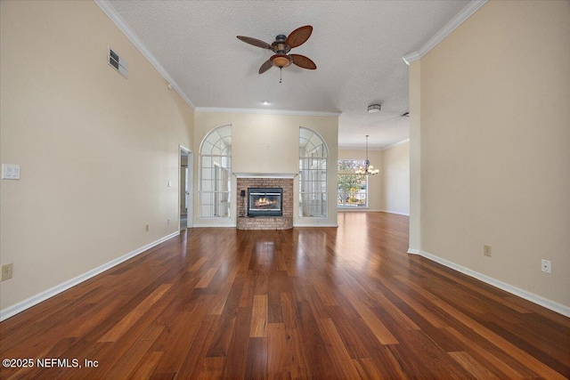 unfurnished living room featuring dark wood-type flooring, ceiling fan with notable chandelier, and a textured ceiling