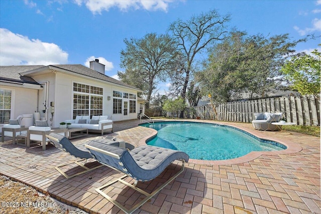 view of pool featuring a fenced in pool, a fenced backyard, a patio, and an outdoor living space