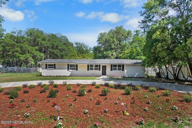 ranch-style home with a front lawn