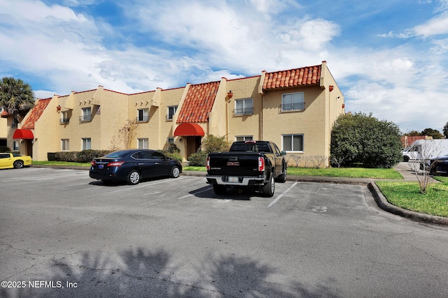 view of property featuring uncovered parking