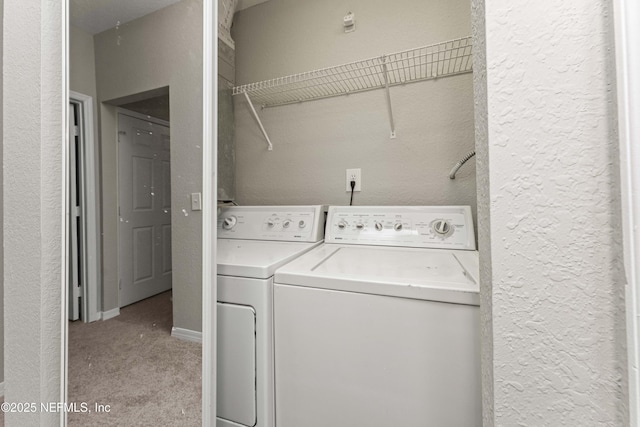 laundry room featuring light colored carpet and washer and dryer