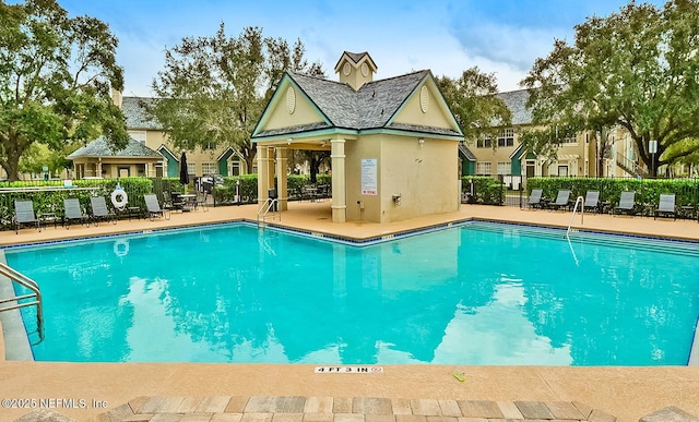 view of swimming pool with a patio