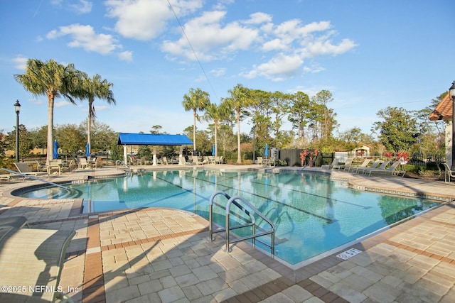 view of pool with a patio area and a hot tub