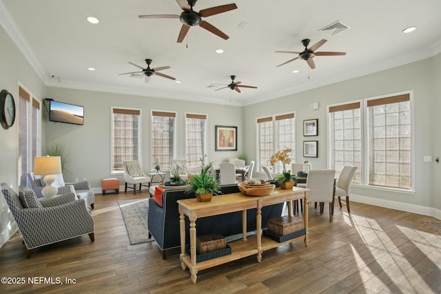 living room featuring crown molding and hardwood / wood-style flooring