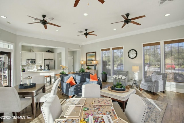 living room with crown molding and hardwood / wood-style floors