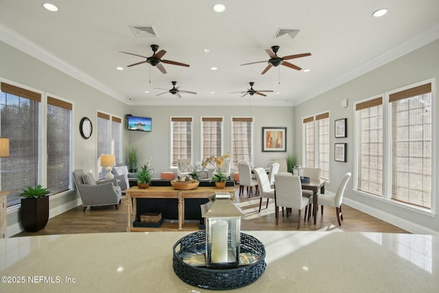 living room with crown molding and hardwood / wood-style floors