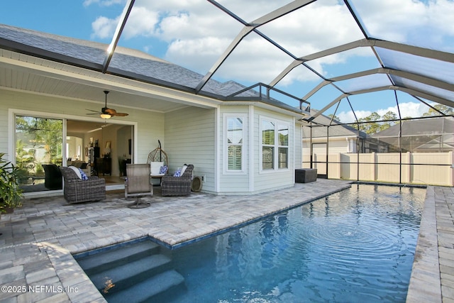 view of pool featuring ceiling fan, an outdoor hangout area, a patio, and a lanai